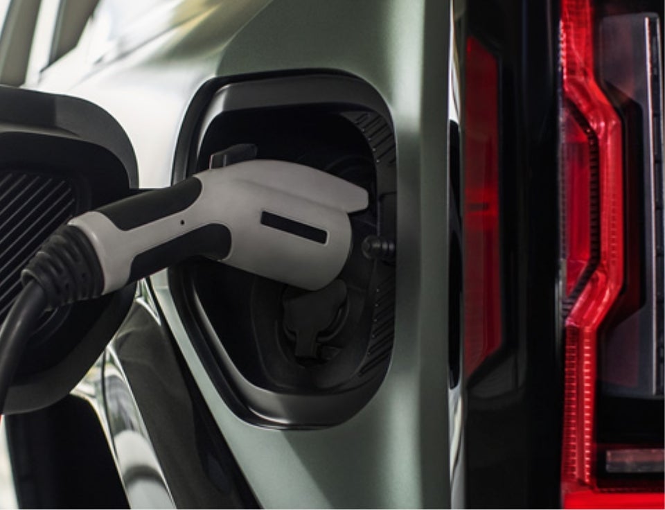 Close up of charging port with charger plugged in on a GMC Hummer EV SUV - Garrett Motors GMC in Coolidge AZ